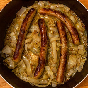 Bratwurst in beer with onions and mustard